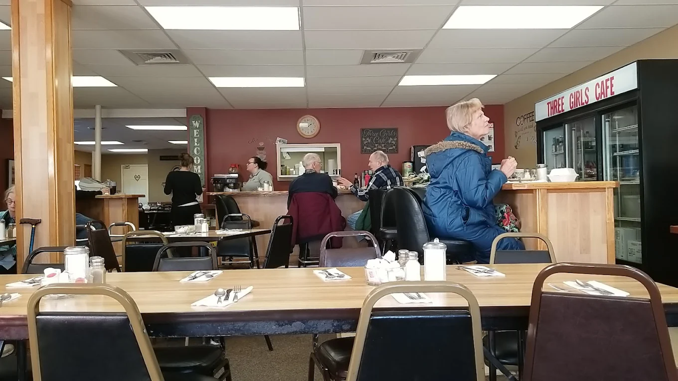 Busy counter and dining room inside Three Girls Cafe