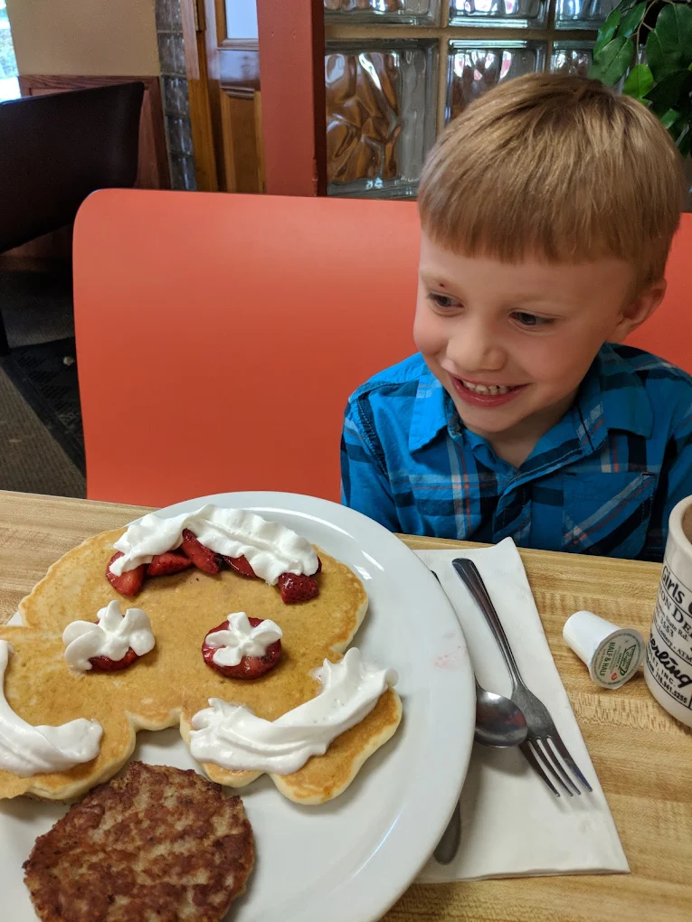 Child smiling at a pancake breakfast